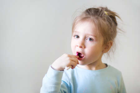 Child brush their teeth on white