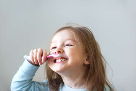 Child brush their teeth on whiteの写真素材