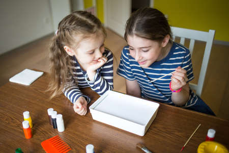 children draw paint on water at home. craft ebru. creative art for kids