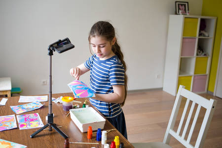 children draw paint on water at home. craft ebru. creative art for kids