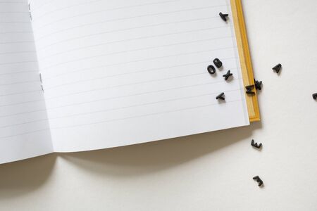 Notepad notebook and 3d black letters on write background. concept back to school office supplies. Teachers desk. Students book. running textの写真素材