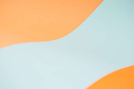 simple two-color background for autumn or Halloween. curved waves of orange and turquoise blue.の写真素材