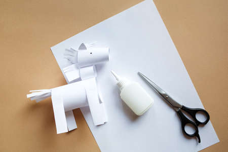 DIY toy animal horse from sheet of white paperの写真素材