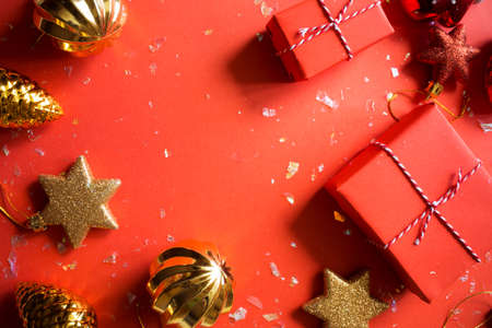 Christmas presents wrapped red paper. golden balls and boxes. New Year flat lay top view background. Template mockup greeting card.の写真素材