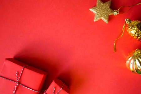 Christmas presents wrapped red paper. golden balls and boxes. New Year flat lay top view background....