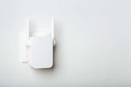 white wifi repeater indoors at home in outlet. wireless router.の写真素材