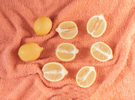 Lemons on peach color background. Summer creative concept.の写真素材