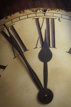 Hands Of An Old Fashioned Clock Showing Five To Twelveの写真素材