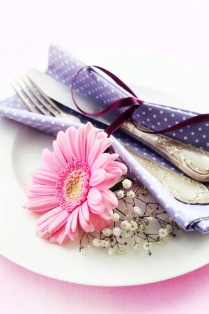 Place Setting With A Gerbera On A Pink Backgroundの写真素材