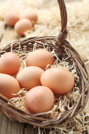 Eggs In A Basket On A Wooden Background
