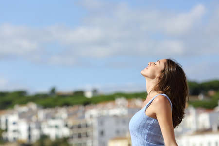Profila of a relaxed tourist breathing fresh air in a rural town on holidayの写真素材