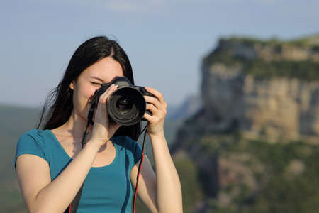 Asian tourist taking photos with dslr camera in the mountainの写真素材