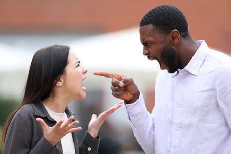 Angry man arguing and pointing to a woman in the street