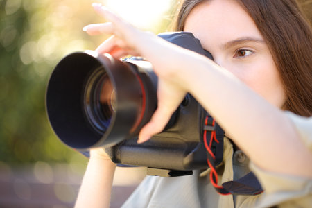Photographer taking photos adjusting focus manually in a parkの写真素材