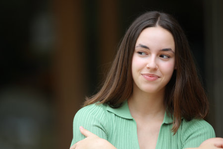 Front view portrait of a woman thinking in the street looking at sideの写真素材