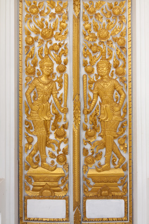 The golden carve door in thai templeの写真素材