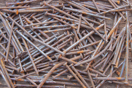 The rusty steel nail on the wood backgroundの写真素材