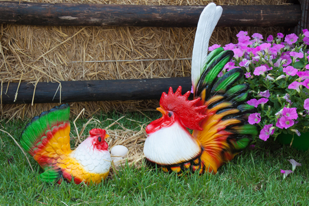 The colorful earthenware of bantam chicken in the flower gardenの写真素材