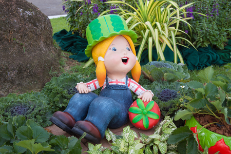The earthenware of girl sit in the flower gardenの写真素材