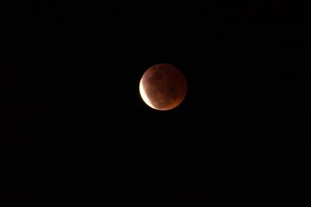 The orange moon in the dark night time