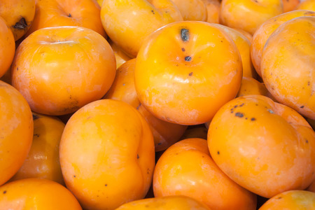 The persimmon fruit background in the marketの写真素材