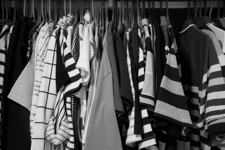 Black and white background of many clothes hang with hanger in wardrobeの写真素材
