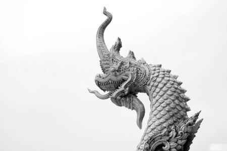 The king of naka statue at thai temple on black and white backgroundの写真素材
