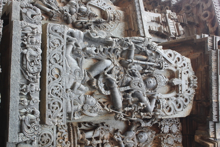 Hoysaleshwara Temple Wall Carving of Lord Shiva Dancing on top of a demonの写真素材