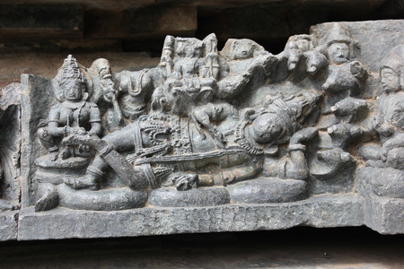 Hoysaleswara Temple wall carved with the sculpture of lord mahavishnu lying on his snake bedの写真素材