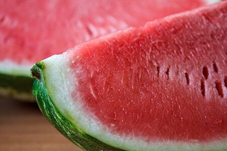 Close-up of a sliced quarter of ripe watermelon with juicy pink red pulpの写真素材