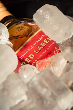 Bottle of "Red Label" brand whiskey on ice.のeditorial素材