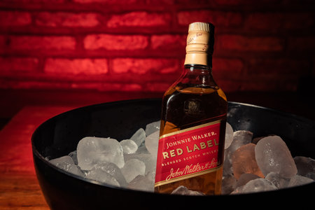 Bottle of "Red Label" brand whiskey on ice.のeditorial素材