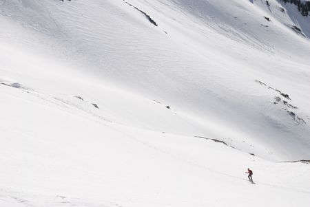 Hiker in the snow mountain in winterの写真素材