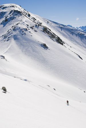 Hiker in the snow mountain in winterの写真素材