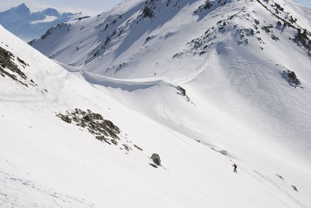Hiker in the snow mountain in winterの写真素材