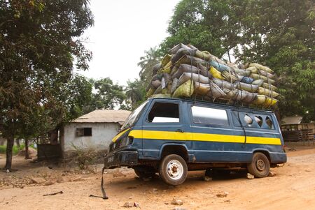 Old and overloaded transport with goods on its roof and insideの写真素材