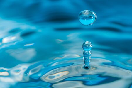 A drop of water create a stunning random water effect.の写真素材