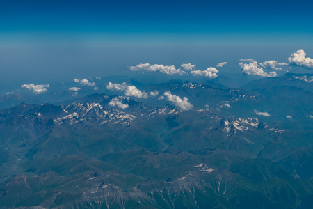 Aerial view of the mountain range with some snow on the topの写真素材