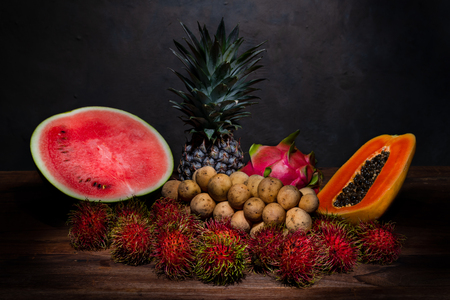 Still life photography of a pile of Thai fruit on the wooden tableの写真素材