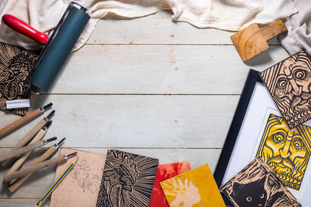 Top view flat lay of Printmaking tools for woodcut relief print arranged to form a picture frameの写真素材