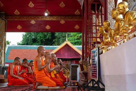 LAMPHUN, THAILAND - Oct 26, 2018 : The monks are organizing a daily evening prayer in Hariphunchai templeのeditorial素材