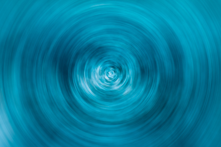 Abstract blue spinning circle with random light spots for background or wallpaperの写真素材