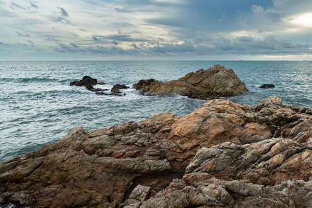 Coastal Sunset, Rocky Coastline with texture of cloudy sky in Chanthaburi province, Thailand