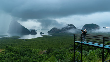 A lady taking pictures of Samet Nangshe islands scenic point on cloudy dayの写真素材