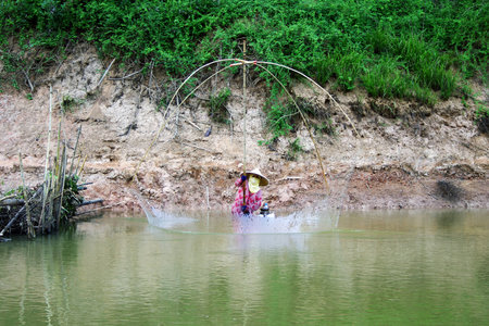 rural people fishing on riverの写真素材