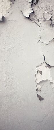 Old Wall with Moldy Peeling White Painting from Humidity. Cracked White Wall as Rusty Concrete Weathered Wall Grunge Background or Abstract Backdrop Wallpaper Vintage Texture Design Copy Space Textの写真素材