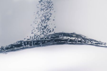 Water splash with bubbles of air, isolated on the white background.