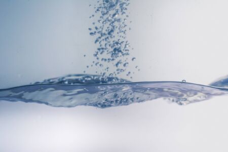 Water splash with bubbles of air, isolated on the white background.