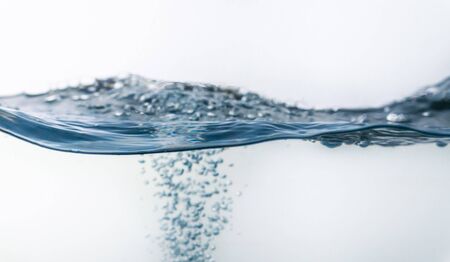 Water splash with bubbles of air, isolated on the white background.の写真素材