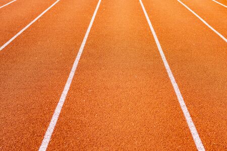 Red running track for athletics at stadiumの写真素材
